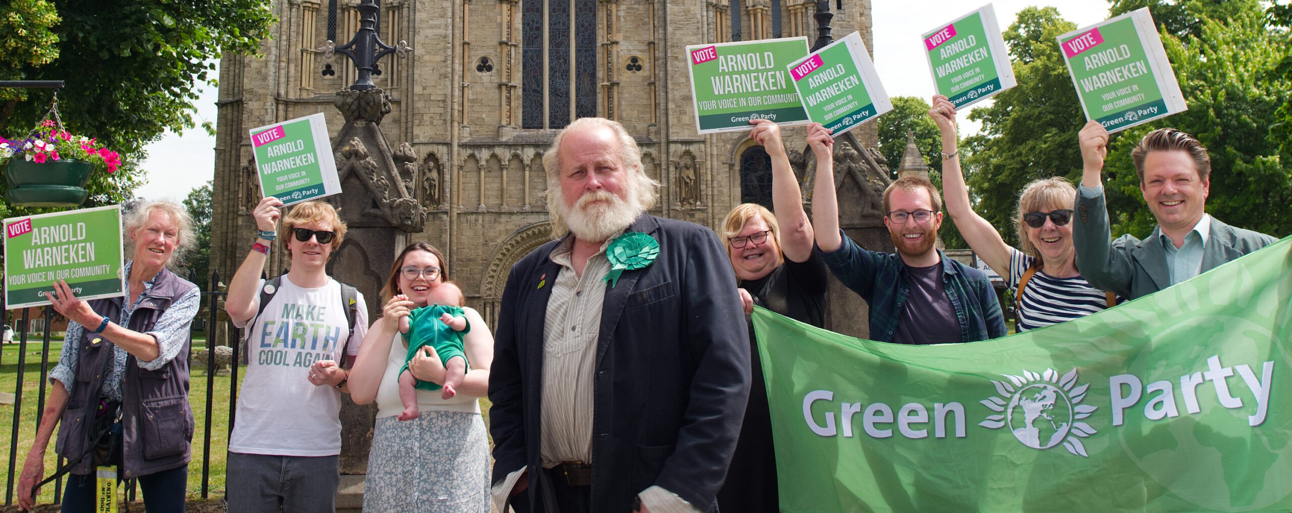 Green Party Parliamentary Candidate for Selby & Ainsty Arnold Warneken, stood outside Selby Abbey with members of the local party waving banners and posters.