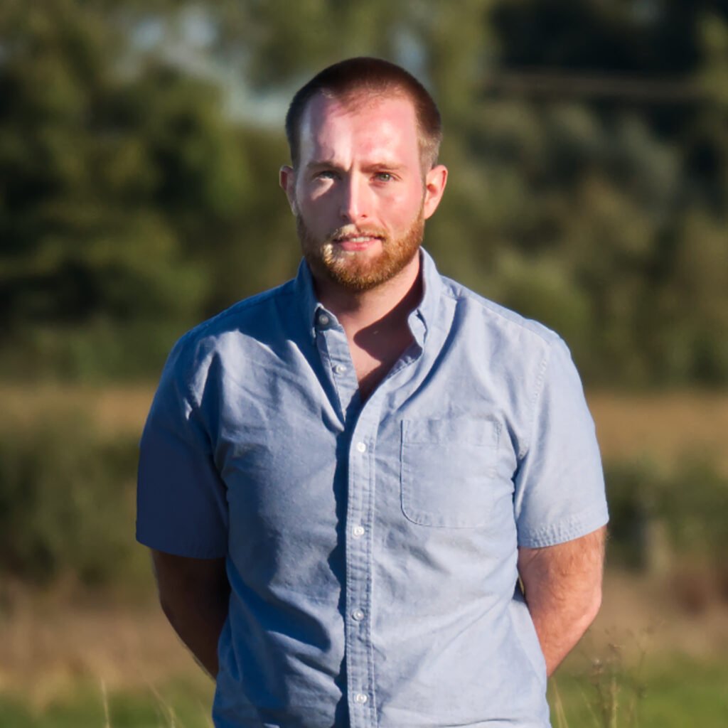 Peter Baumann in a blue shirt in a field